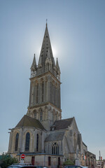 Obraz premium Langrune-Sur-Mer, France - 07 18 2023: View of the facade of the St. Martin's Church from the road.