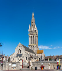 Fototapeta na wymiar Langrune-Sur-Mer, France - 07 18 2023: View of the facade of the St. Martin's Church from the road.