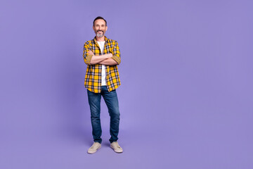 Full size photo of friendly nice man wear yellow plaid shirt denim trousers standing arms crossed...
