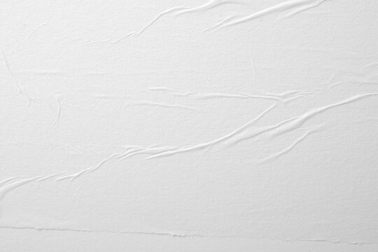 Pronounced creases on white paper. Abstract background.