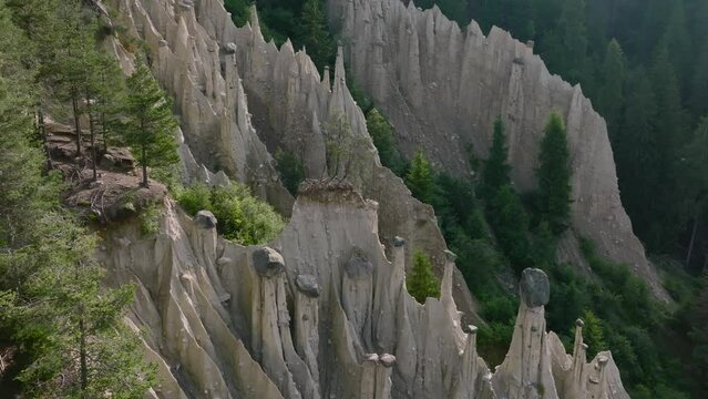 Aerial Drone shot over the Earth pyramids of Platten in South Tyrol in Alps near to Bruneck or Brunico, Bolzano, Italia