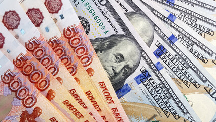 Currency exchange. Bills of $ 100 and 5000 rubles. Cash banknotes. Background of money. Economics...