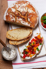 Bruschetta from homemade bread with cottage cheese and sprat pate and tomatoes on a wooden background. Rustic style.