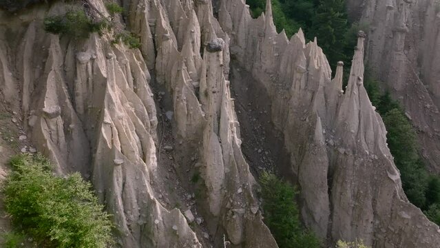 Aerial Drone shot over the Earth pyramids of Platten in South Tyrol in Alps near to Bruneck or Brunico, Bolzano, Italia