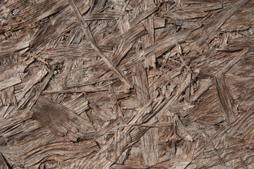 brown chipboard closeup.wooden detailed background with sawdust and shavings. Seamless compressed wood particle board background texture. Tileable light brown pressed redwood