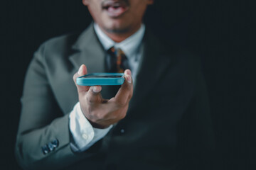 Businessman is using smartphone to connect with customers, online communication concept.
