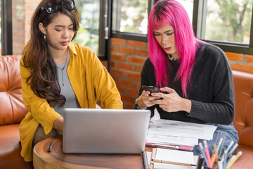 LGBTQ+ transgender man Beautiful Authentic Specialist with Pink Hair and Non-binary trans working together Working Design in creative workplace team work colleagues Gender equality