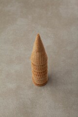 Stack of waffle cones arranged on a gray surface