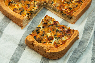 shortbread vegetable freshly baked homemade pie on the white table. crust baking with mushrooms and vegetables on a beige tablecloth. shortcrust pastry home baking concept