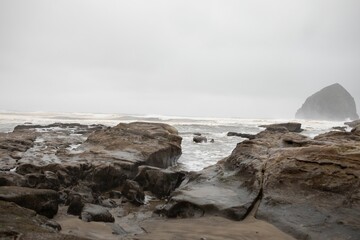 Rainy day shot of the ocean from the Pacific Coast Highway with overcast skies and roaring waves