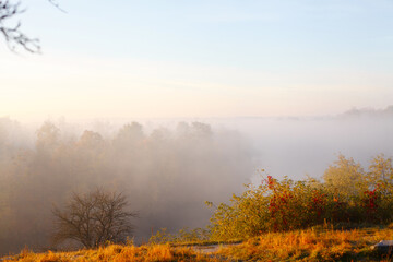 Morning autumn landscape with fog on river