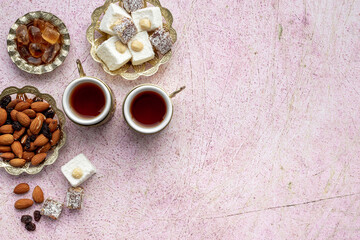 Fototapeta premium Muslim holiday with tea in traditional bronze cups with sweets