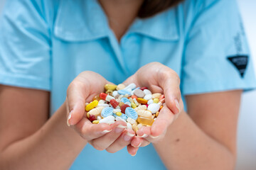 Woman Holding a Pile of Pills