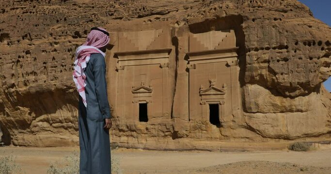 Saudi man in front of tombs in Madain Saleh  Alula  Saudi Arabia