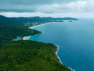 Fototapeta na wymiar .aerial top view amazing freedom beach small white sand beach with perfect nature. .white wave hit the rock around island. .green forest peaceful. green sea, and clear sand landscape. Paradise beach..