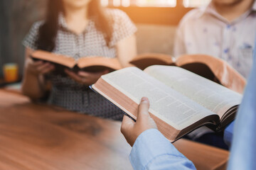 A Group of Christian friends are reading and study bible together in home or Sunday school at...