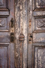 Wooden door with ornately-crafted door knobs