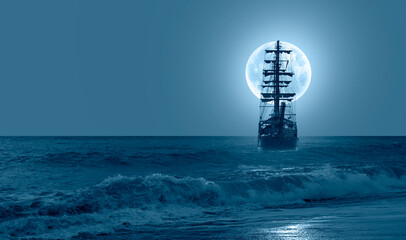 Sailing old ship in calm sea - Night sky with moon in the clouds 