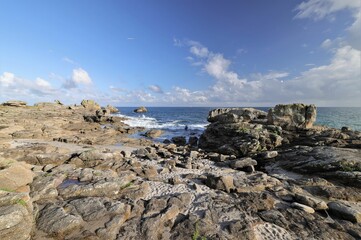 Fototapeta na wymiar Scenic view of ocean waves crashing against the rocky shoreline, Brittany, France