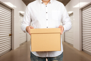 Man with box. Businessman in storage building. Cropped businessman without face. Entrepreneur...