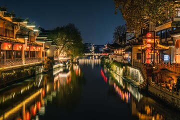 Scenic view of a picturesque river winding through a cityscape, with traditional old architecture