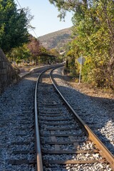 Fototapeta na wymiar Vertical shot of a winding railway track curves through the landscape