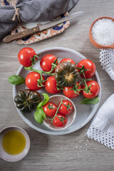 Selection of fresh tomatoes on a grey plate with napkin