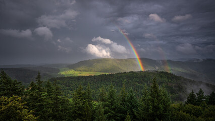 The end of the rainbow during a summer thunderstorm over the northern Black Forest