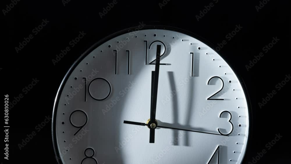 Poster timelapse of the time passing fast with the clock isolated on the empty black background