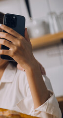 Cropped photo of Freelancer business Asian woman holding coffee cup and at doing planning analyzing the financial report, business plan investment, finance analysis the workplace.