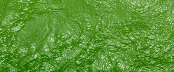 Closeup of mint green transparent clear calm water surface texture with splashes and bubbles. waves on a surface of green water.