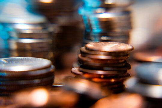 Nickels dimes and quarters with a shallow depth of field and selective focus about to collapse