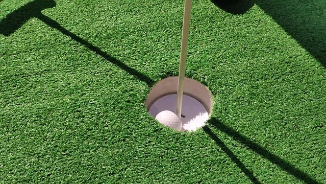 Summer hobbies. unrecognizable person playing mini golf