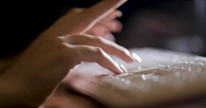 Female hand typing on white keyboard