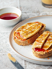 Tasty toast for breakfast with peanut butter banana and honey. Close up food photo
