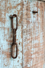 An old steel chain door lock on the old wooden door