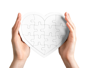 Heart-shaped puzzle in hands isolated on white