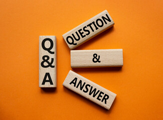 Q and A - Question and Answer. Wooden cubes with words Q and A. Beautiful orange background. Business and Q and A concept. Copy space.