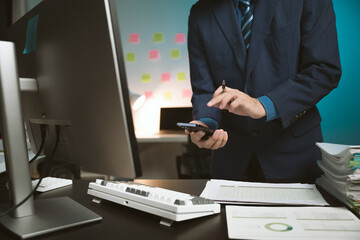 Young Asian businessman talking on the phone
late night hustle ambitious Working overtime talking...