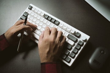 young man working at night Work comfortably on your smartphone. Social media chat at the office