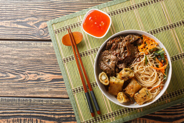 Vietnamese beef noodles salad bun bo xao is filled in fresh herb, savory beef, vegetables and fried...