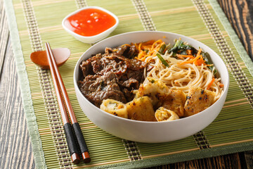 Vietnamese beef noodles salad bun bo xao is filled in fresh herb, savory beef, vegetables and fried...