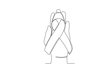 A hand holds the baby's birth ribbon. Pregnancy and infant loss awareness month