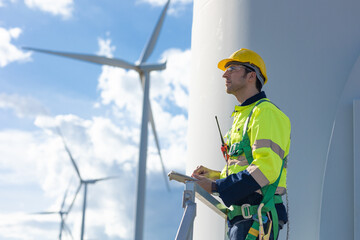 Smart confident engineer male Wind Turbines service team standing looking sky forward for the...