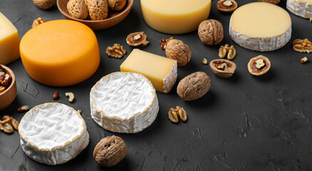 delicious variety of cheeses on black background,copy space