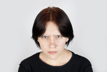 Dramatic portrait of a teenage girl, the girl is a little angry, has a scratch on face and a...