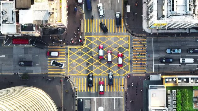 Car traffic transport on road, pedestrian people walk cross zebra crossing, crossroad junction in Mong Kok, Hong Kong downtown. Drone aerial top view. Asian lifestyle, Asia transportation city life