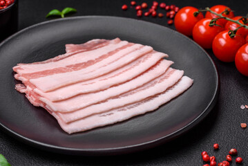 Fresh raw bacon cut into slices with salt, spices and herbs