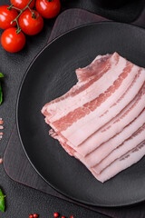 Fresh raw bacon cut into slices with salt, spices and herbs