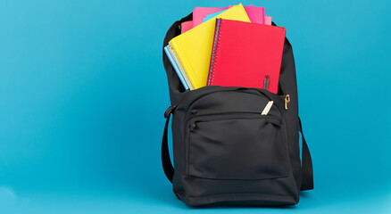 open medium black bag with school books